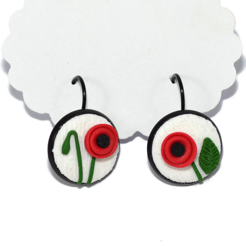 Ατσάλινα σκουλαρίκια λίγο κρεμαστά με ανάγλυφες παπαρούνες από πηλό